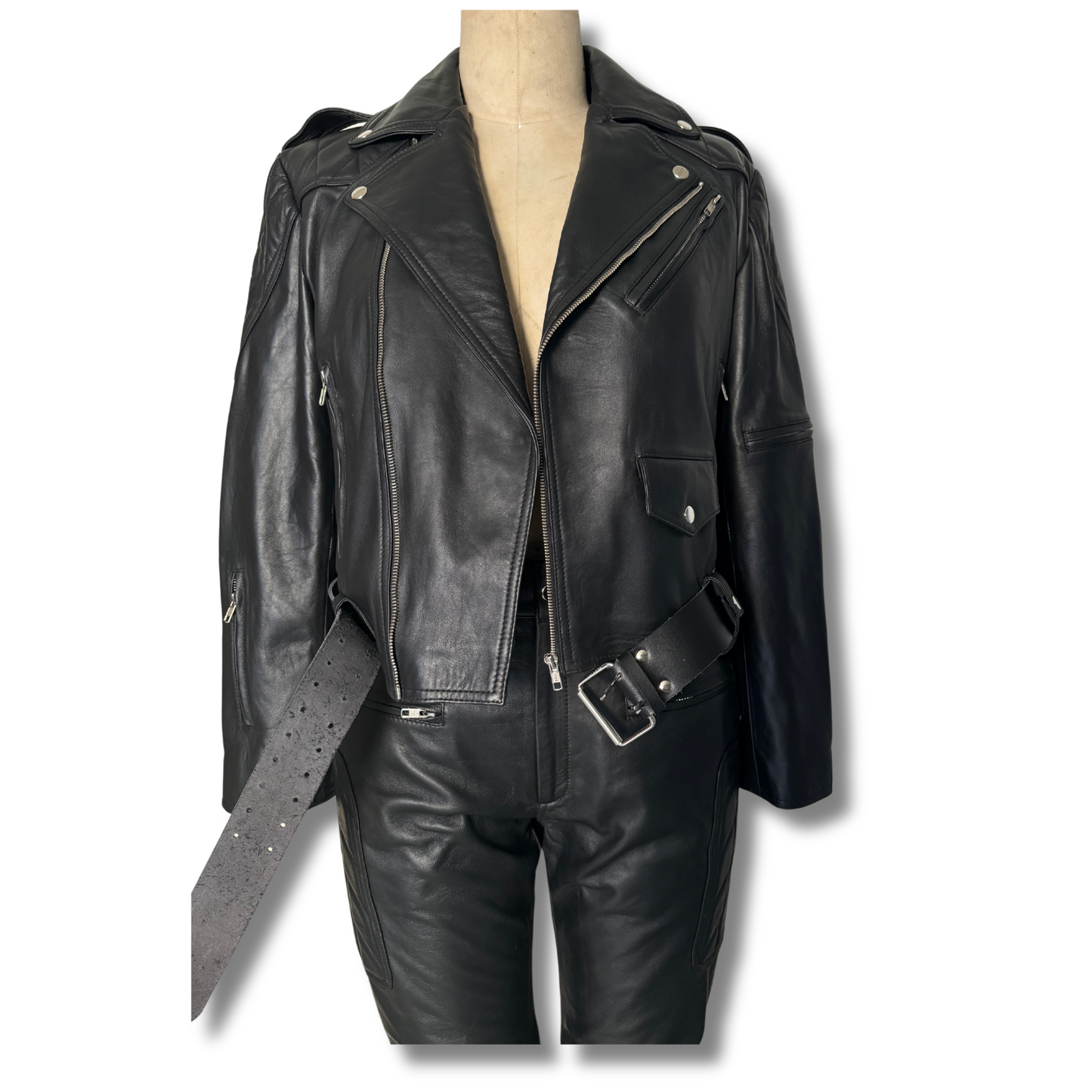 Discover our black genuine leather two-piece set featuring a lapel collar jacket with multiple body pockets and a waist belt, paired with pants that include front zipper pockets and quilted knee padding for extra protection. This durable, versatile, and timeless set combines style and functionality.