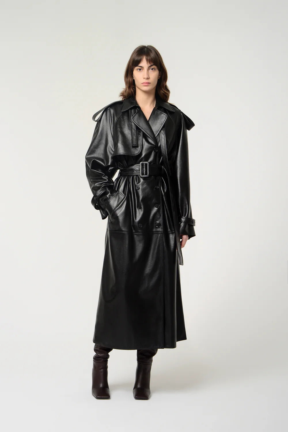 Black leather long trench coat with double-breasted design, lapel collar, shoulder and wrist straps, and detachable waist belt – Movenera.